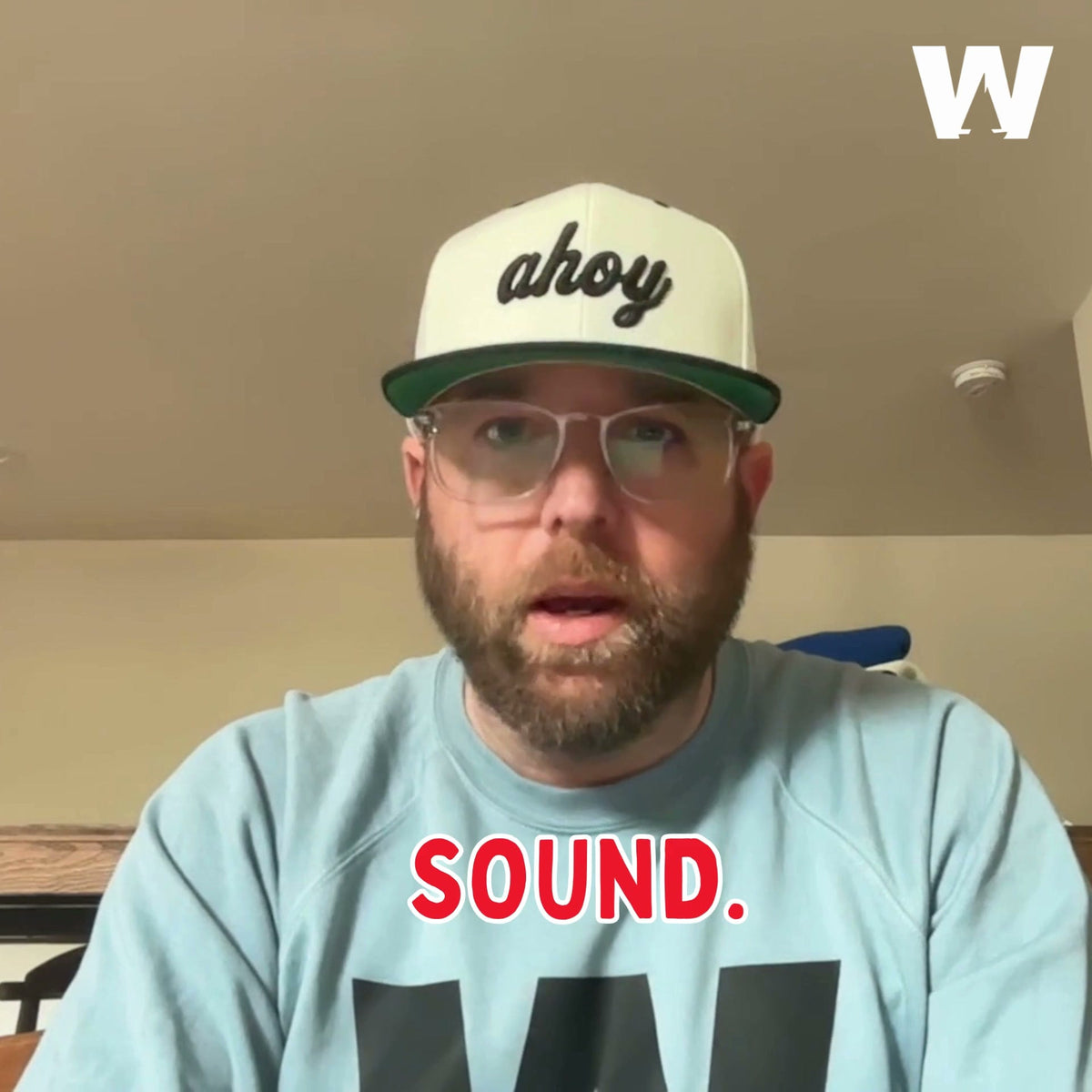 Aaron, founder of Weathered Sailor, in an ahoy cap and Weathered Sailor sweatshirt speaking to camera