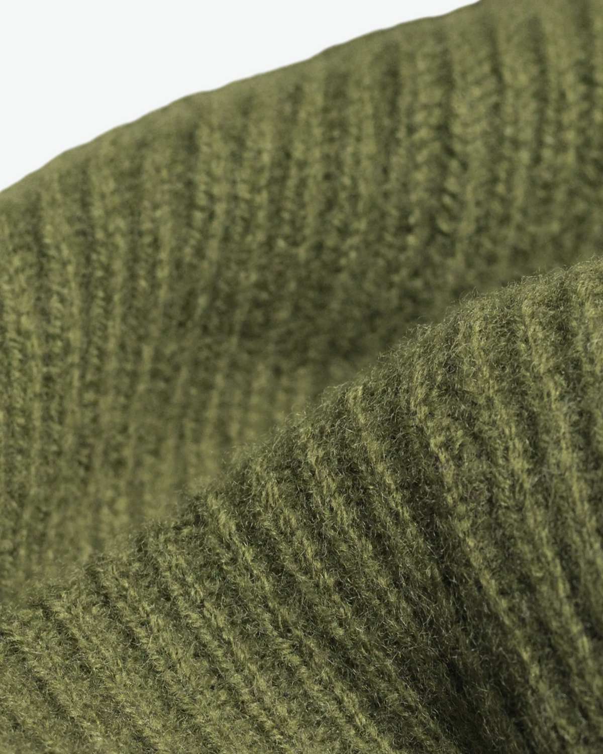 Close-up of the olive beanie's ribbed knit and folded cuff.