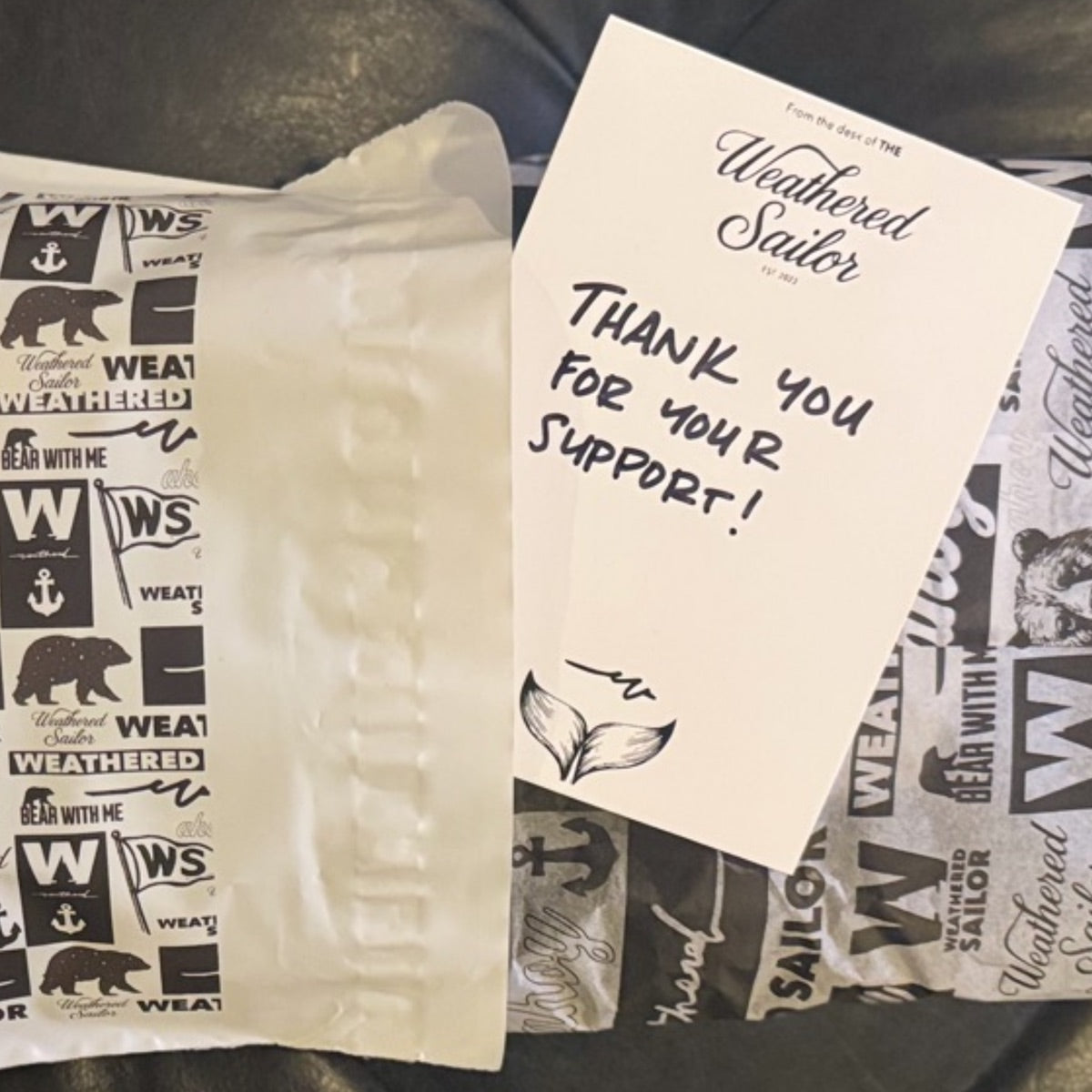 A Weathered Sailor order packed to ship — a branded mailer, tissue, and a handwritten thank-you-for-your-support card.