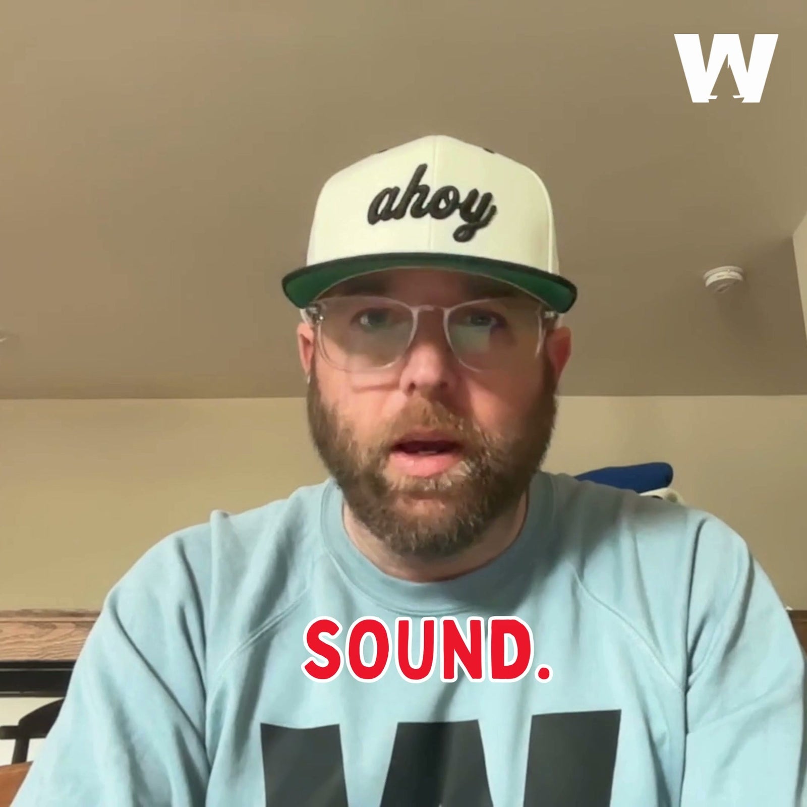 Aaron, founder of Weathered Sailor, in an ahoy cap and Weathered Sailor sweatshirt speaking to camera