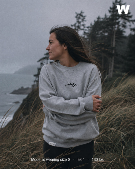 Model wearing the Athletic Heather Puff Dub Heavy Terry Crew on a foggy Pacific Northwest coastal bluff — size S