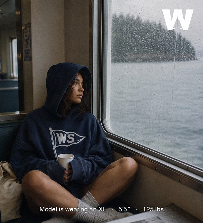 Model wearing the Ink Blue Burgee Heavy Terry Hood on a ferry crossing to the San Juan Islands — size XL, oversized fit